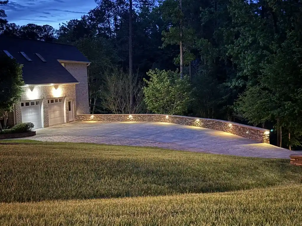 A driveway illuminated by landscape lighting installation in Raleigh, NC.