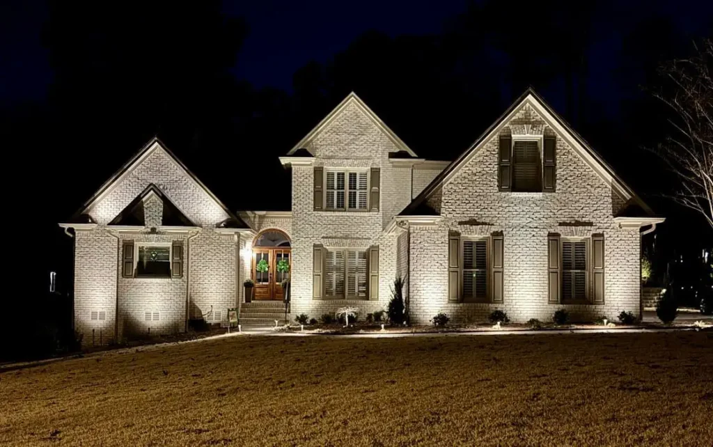 A house light up as a result of outdoor lighting repair in the Raleigh area.