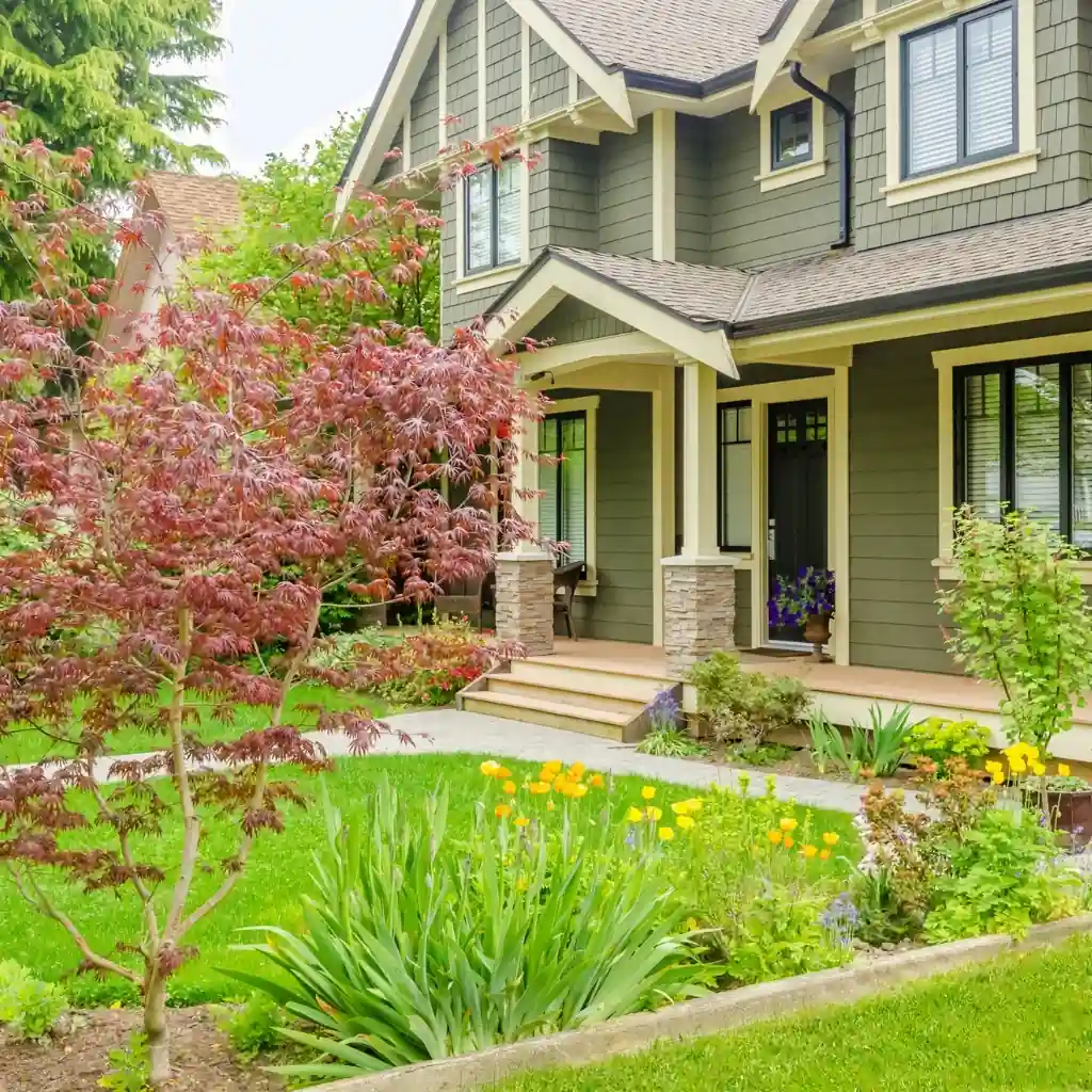 Apex home in the day time with spring landscaping.